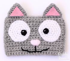 a crocheted gray and white cat purse with pink ears on it's face