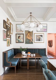 a dining room with blue booths and pictures on the wall