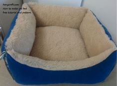 a blue and white dog bed on the floor