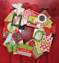 a christmas wreath made out of cards on a red door