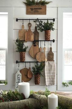 the kitchen is decorated for christmas with wood utensils and greenery hanging on the wall