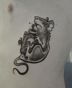a man's chest with a tattoo of a mouse and a teapot on it