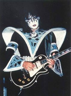 a man in costume playing an electric guitar