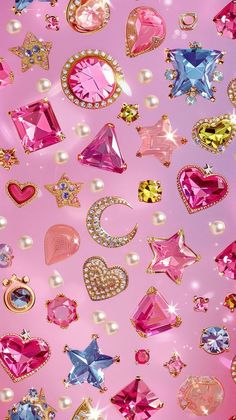 many different colored jewels and pearls on a pink background