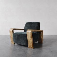 a chair that is made out of wood and has a green velvet upholstered seat