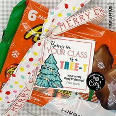 some candy wrapped in plastic and tied to a ribbon on a table with other candies