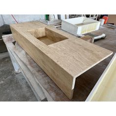 a large wooden sink sitting on top of a hard wood flooring workbench