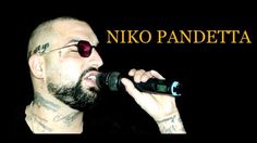 a man with sunglasses on holding a microphone in front of his face and the words niko pandetta above him