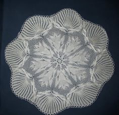 a crocheted doily is shown on a black background with white trimmings