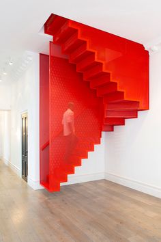 a red staircase in the middle of a room