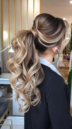 a woman with long blonde hair in a ponytail