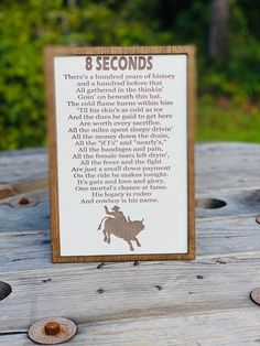 a sign that is sitting on top of a wooden table in front of some coins