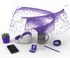 a cup with purple paint on it next to other items and gadgets, including a cell phone