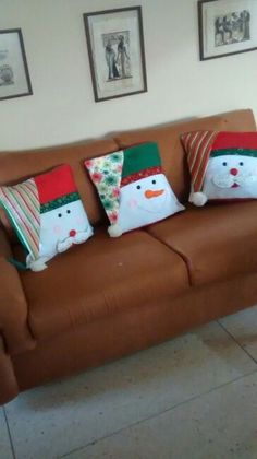 the couch is decorated with christmas pillows and snowmen
