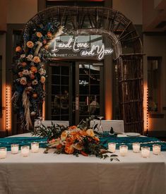 a table with candles and flowers on it