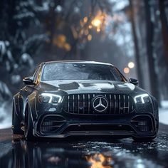 the mercedes benz amg coupe is driving on a wet road in the woods at night