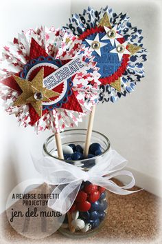 two red, white and blue pinwheels in a jar filled with candies