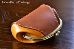 a brown leather case sitting on top of a wooden table