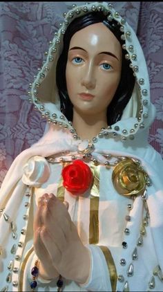 a close up of a mannequin with a rose in her hand