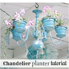 a blue chandelier with flowers hanging from it's sides and the words, chandelier planter floral