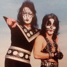 two men in black and white face paint posing for a photo