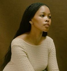 a woman with long black hair sitting down