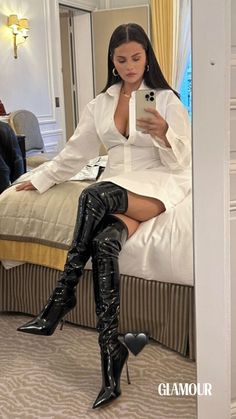 Yes, a white long-sleeve button-up isn't just sexy when stolen from your partner's closet for breakfast in bed or paired with jeans and a sharp bob à la Uma Thurman, though that's definitely still a fierce look. In her latest mirror selfie, the 31-year-old pop star styled a crisp shirt dress—which she left unbuttoned enough to show off a peak at her bra—with classic gold jewelry and sky-high patent leather stiletto boots, giving a brand-new meaning to “legs for days.” Instagram, Selena Gomez, Scarlett Johansson, Instagram Fashion, Celebs, Selena