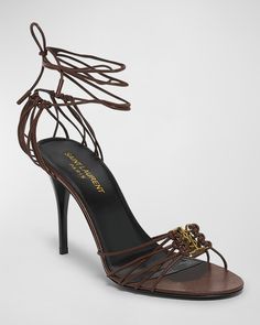 Saint Laurent strappy leather sandals with YSL medallion.    3.50 in / 90 mm stiletto heel.    Open toe.    Caged vamp and heel.    Wraparound ankle ties.    Leather lining and outsole.    "Babylone" is made in Italy. Dark Brown Heels, Open Heels, Ysl Shoes, Rich Girls, Tie Heels, Strappy Leather Sandals, Ankle Tie Sandals, Classy Shoes