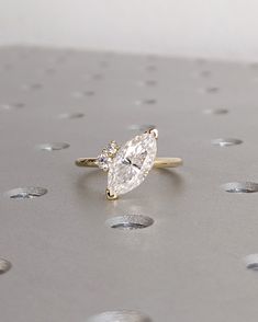 a diamond ring sitting on top of a table