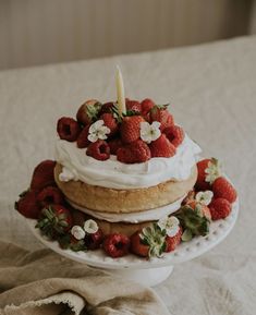 a cake with strawberries and whipped cream on top