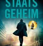 a man walking down a street in front of a building with the words staats geheim written on it