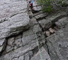 a man climbing up the side of a mountain