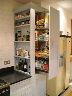 an open pantry in the middle of a kitchen