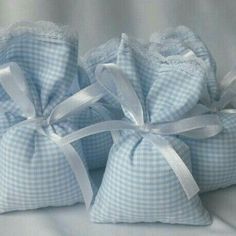 three blue bags with white bows on them