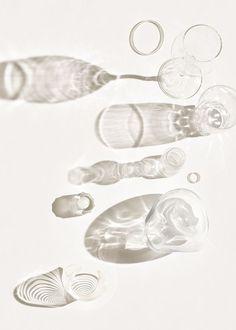 an assortment of plastic objects on a white surface, including two spoons and one pair of scissors