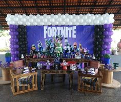 a fortnite themed birthday party with balloons and decorations