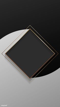 two square black and gold frames sitting on top of a white round table with a gray background