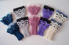 six crocheted mittens sitting on top of a white table next to each other