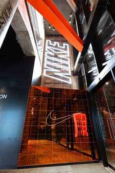 the interior of a building with an orange and black design on it's glass wall