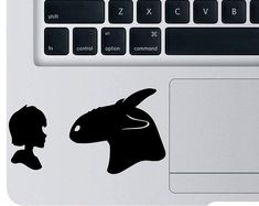 a laptop computer with a sticker of a goat and man's head on the keyboard