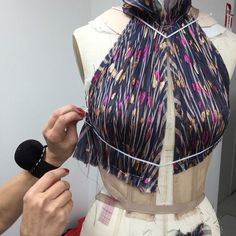 a mannequin is being worked on by a woman