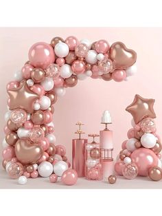 a pink and white balloon arch with balloons