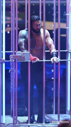 the wrestler is in jail with his hand on his chest and looking out from behind bars