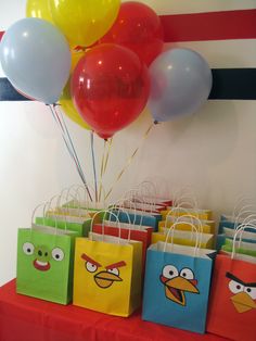 a bunch of bags with angry birds on them and some balloons in the shape of an angry bird