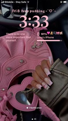 a woman's hand holding a pink purse with the number 3 533 on it