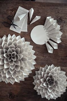 paper flowers and scissors on a wooden table