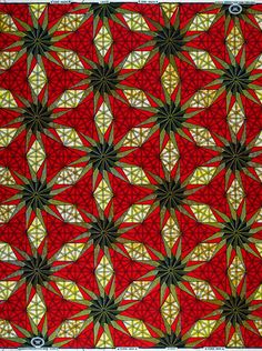 a red and yellow quilt with many different designs