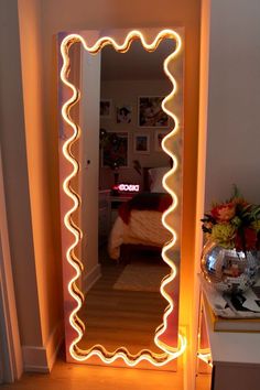 an illuminated mirror in the corner of a room