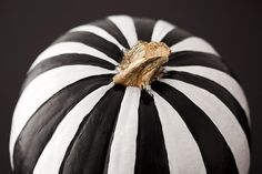 a black and white striped pumpkin sitting on top of a table