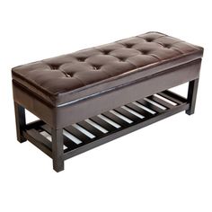 a brown leather bench sitting on top of a wooden shelf